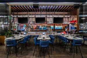 Interior of the Kona Grill Riverton location–view of a few tables and what looks like a bar area
