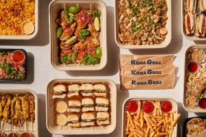 Above view of a series of meals including hamburgers, fries, grilled chicken, and more.