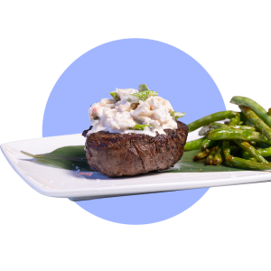 Plate of Kona Grill Surf and Turf with a side of green beans.